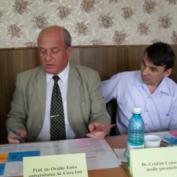 Prof Dr Ovidiu Toma and Dr Cojucaru discuss cards